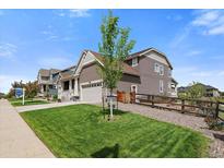 Beautiful single-Gathering home with well-maintained lawn, landscaping, and a two-car garage at 848 Sandstone Cir, Erie, CO 80516