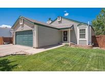 Charming single-Gathering home featuring a well-manicured lawn and a two-car garage at 11337 E 1St Ave, Aurora, CO 80010