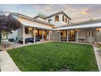 Expansive backyard featuring a lush lawn, covered patio, and stylish outdoor seating, perfect for entertaining at 4525 King St, Denver, CO 80211