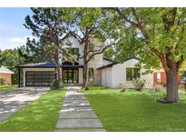 Stunning two-story home with modern design and landscaped lawn at 62 N Jasmine St, Denver, CO 80220