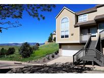 Inviting townhouse with mountain views, private entrance, and an attached garage on a sunny day at 1767 High Plains Ct, Superior, CO 80027