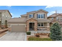 Charming two-story home with stone accents, a covered porch, and a spacious two-car garage at 10570 Sundial Rim Rd, Highlands Ranch, CO 80126