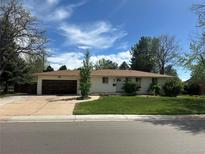Charming single-story home with a well-maintained lawn and attached garage at 1836 E Mineral Ave, Centennial, CO 80122