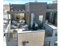 Inviting rooftop deck with outdoor seating, grill, and views into a cozy living space, perfect for entertaining at 2442 Champa St, Denver, CO 80205