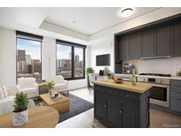 Bright, modern living room with large windows offering stunning city views, an island, and sleek, gray kitchen cabinets at 1750 Wewatta St # 1536, Denver, CO 80202