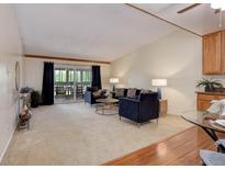 Cozy living room featuring plush seating and sliding door access to an outdoor balcony at 625 S Alton Way # 10D, Denver, CO 80247