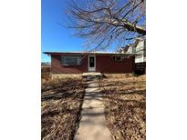 Charming brick home with a well-maintained front yard and walkway to the entrance at 1265 Yates St, Denver, CO 80204