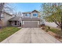 Charming two-story home with a well-maintained lawn and attached two-car garage and inviting curb appeal at 6774 St Vrain Ranch Blvd, Firestone, CO 80504