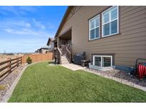 Well-maintained backyard featuring artificial turf, wood fence, and access to a covered deck on a sunny day at 4475 Hidden Gulch Rd, Castle Rock, CO 80104
