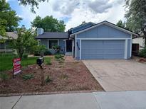 Charming single-Gathering home featuring an attached two-car garage and a well-manicured front yard at 3613 S Olathe St, Aurora, CO 80013