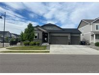 Charming single-Gathering home with a three-car garage, manicured lawn, and tasteful stone accents at 5204 Lake Port Ave, Longmont, CO 80504