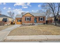 Charming brick home with a well-manicured front yard and attached garage at 1610 Trenton St, Denver, CO 80220