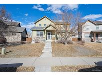 Charming two-story home with landscaped front yard and inviting entrance at 11883 E 111Th Ave, Commerce City, CO 80640