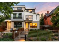 Modern two-story home with sleek lines, large windows, and landscaped front yard at 2242 W 34Th Ave, Denver, CO 80211