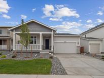 Inviting single-Gathering home with a charming front porch and a well-manicured lawn at 45928 Gentry Ave, Bennett, CO 80102