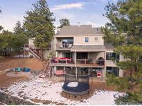 Luxury home with expansive deck, trampoline, and mountain views at 3028 Olympia Cir, Evergreen, CO 80439