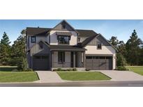 Beautiful two-story home featuring a covered porch, white siding, and a two-car garage on a lush landscaped lot at 39816 Floyd St, Elizabeth, CO 80107