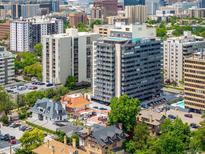 Stunning aerial view of high-rise condos surrounded by lush greenery and city views at 790 N Washington St # 1210, Denver, CO 80203