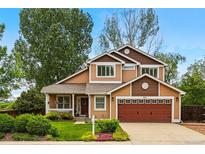 Charming two-story home with a well-manicured lawn and a two-car garage in a quiet neighborhood at 301 Widgeon Ln, Longmont, CO 80503