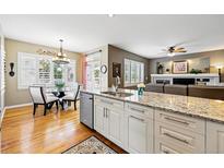 Bright kitchen features an island with granite countertops, stainless steel appliances and a breakfast nook at 301 Widgeon Ln, Longmont, CO 80503