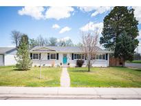 Charming ranch-style home with a well-maintained lawn and inviting turquoise front door at 986 S Jersey St, Denver, CO 80224