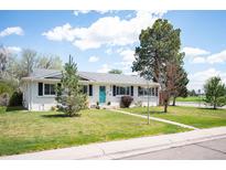Charming ranch-style home with a well-maintained lawn and inviting turquoise front door at 986 S Jersey St, Denver, CO 80224