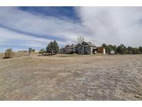Sprawling home on acreage features mature trees and charming curb appeal at 10510 Inspiration Dr, Parker, CO 80138