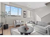 Bright living room features neutral tones, large windows, and modern decor at 4733 E Iliff Ave, Denver, CO 80222