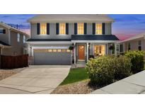 Charming two-story home featuring a well-manicured lawn, inviting front porch, and attached two-car garage at 11866 High Desert Rd, Parker, CO 80134