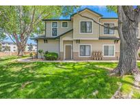 Inviting two-story home with lush green lawn and mature trees at 8707 E Florida Ave # 709, Denver, CO 80247