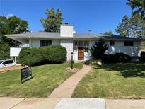 Charming single-story home features a well-manicured lawn, mature trees, and a welcoming entrance at 2789 S Ivan Way, Denver, CO 80227