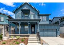 Charming blue two-story home with a welcoming front porch and attached two-car garage at 5608 Grandville Ave, Longmont, CO 80503