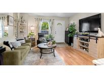 Cozy living room featuring a sofa, coffee table, and large TV at 1811 S Quebec Way # 134, Denver, CO 80231