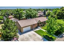 Charming ranch-style home features a well-maintained lawn, mature trees, and an attached two-car garage at 9170 Aspen Dr, Thornton, CO 80229