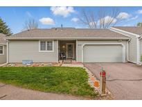 Charming single Gathering home featuring an attached garage and a well-manicured front lawn at 2838 S Heather Gardens Way # A, Aurora, CO 80014