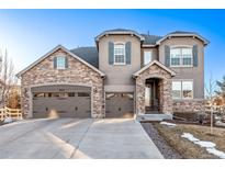 Charming two-story home with stone accents, a three-car garage, and a well-maintained front yard at 2627 Hillcroft Ln, Castle Rock, CO 80104
