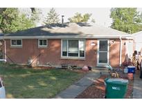 Cozy brick home featuring a well-kept lawn and charming front entrance, perfect for suburban living at 3213 Scranton St, Aurora, CO 80011