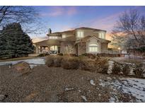 Two-story house with stone accents and a large front yard at 7285 Sagebrush Dr, Parker, CO 80138
