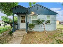 Charming front exterior with a cute covered porch and steps leading to the front door at 1200 Newark St, Aurora, CO 80010