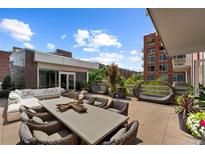 Expansive rooftop patio features outdoor lounge, dining furniture, and inviting views at 2800 E 2Nd Ave # 202, Denver, CO 80206