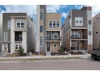 Three-story townhouses with modern design, featuring neutral color palettes and balconies at 2615 Mayotte Way, Castle Rock, CO 80109