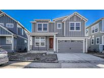 Charming two-story home with gray siding, covered porch, and an attached two-car garage at 246 Mohawk Cir, Superior, CO 80027