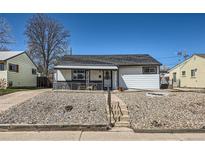 Charming single-story home with a rockscaped front yard and inviting covered porch at 433 S Xavier St, Denver, CO 80219