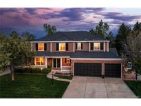 Beautiful two-story home with manicured lawn, three-car garage, and welcoming front porch at 556 Rachael Pl, Castle Pines, CO 80108