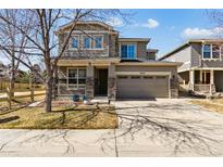 Charming two-story home featuring a two-car garage and inviting front porch at 4935 S Zephyr St, Littleton, CO 80123
