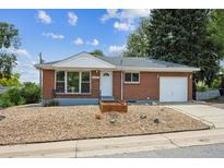 Charming brick home with a well-maintained front yard and attached one-car garage at 10452 Washington Way, Northglenn, CO 80233