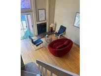 Cozy living room with fireplace, stylish seating, and natural light from a large window at 4899 S Dudley St # K18, Littleton, CO 80123