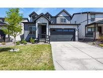 Charming two-story home featuring a modern design, well-manicured lawn, and a spacious two-car garage at 27893 E 6Th Pl, Aurora, CO 80018