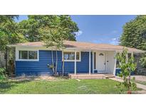 Charming blue single-story home with well-maintained lawn and covered porch, perfect for enjoying the outdoors at 1325 Lima St, Aurora, CO 80010