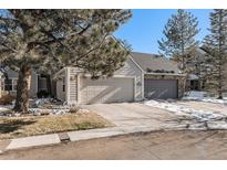Two-car attached garage featuring a concrete driveway at 10000 E Yale Ave # 7, Denver, CO 80231